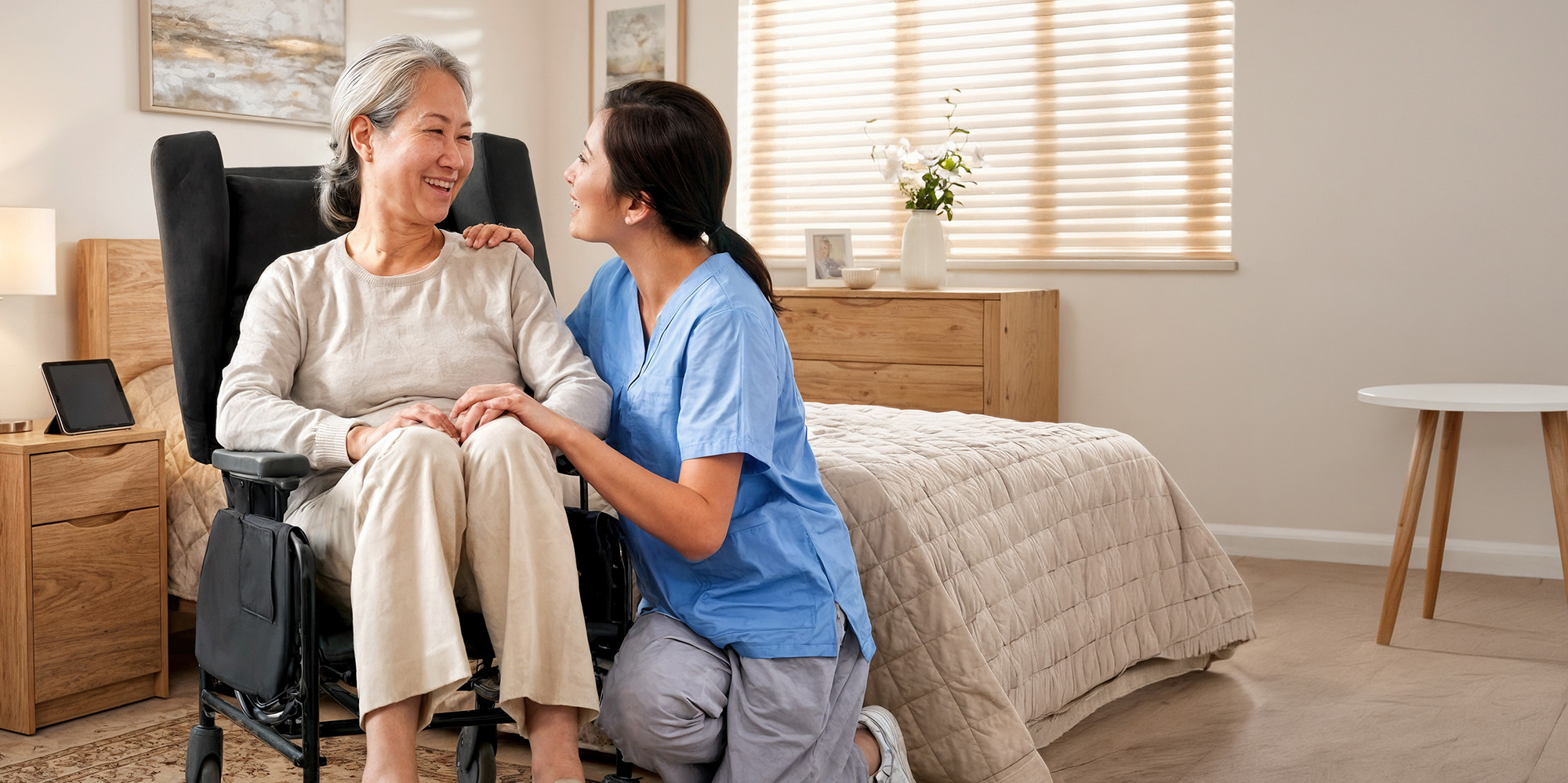 Care worker beside a seated elderly patient.